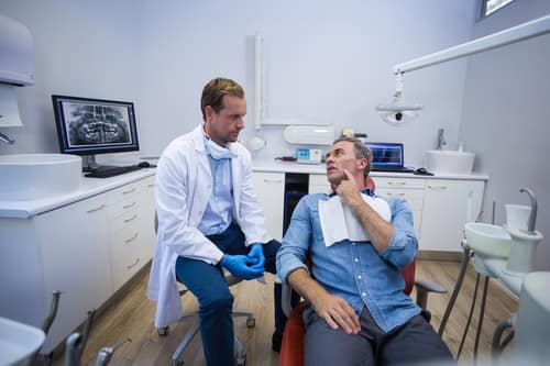 male patient talking to a dentist