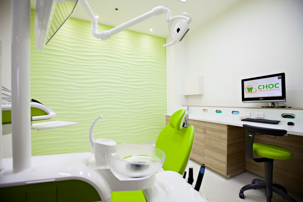 Dentist chair and computer station in Coburg Hill white and green themed surgery room
