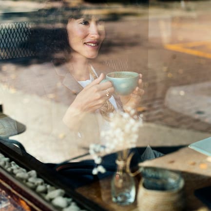 Woman having coffee at a coffee shop