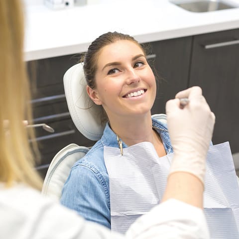 Happy female patient getting dental checkup