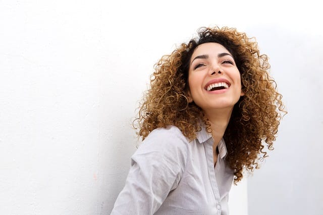 woman smiling against white background