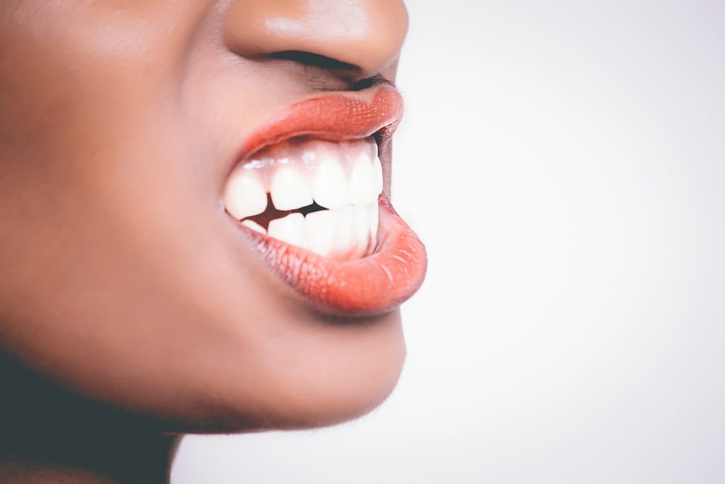 Woman showing full teeth