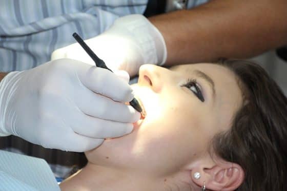 female patient being checked by a dentist