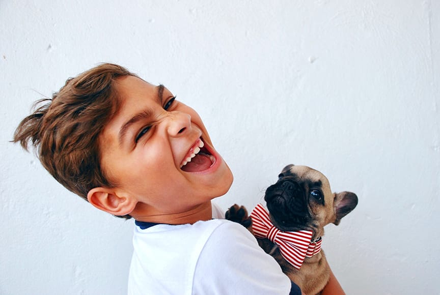 Happy young boy with a small dog